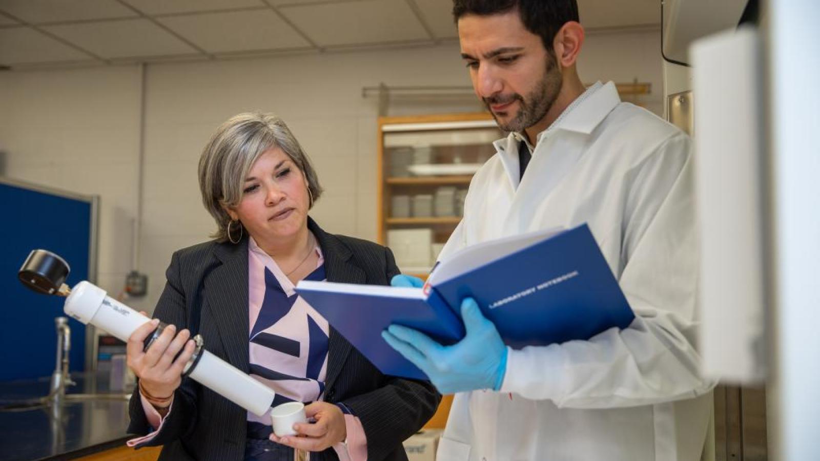 Researchers with equipment in a lab