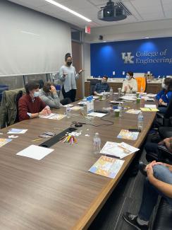Masked students working at a conference table