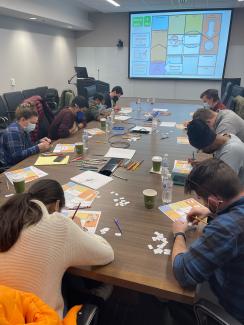Masked students working at a conference table