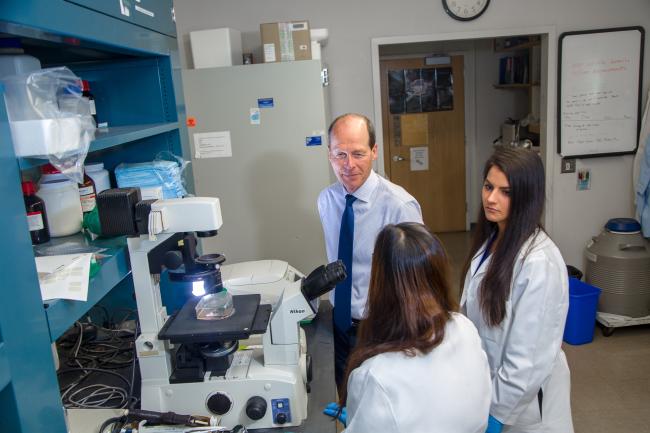 Researchers with equipment in a lab